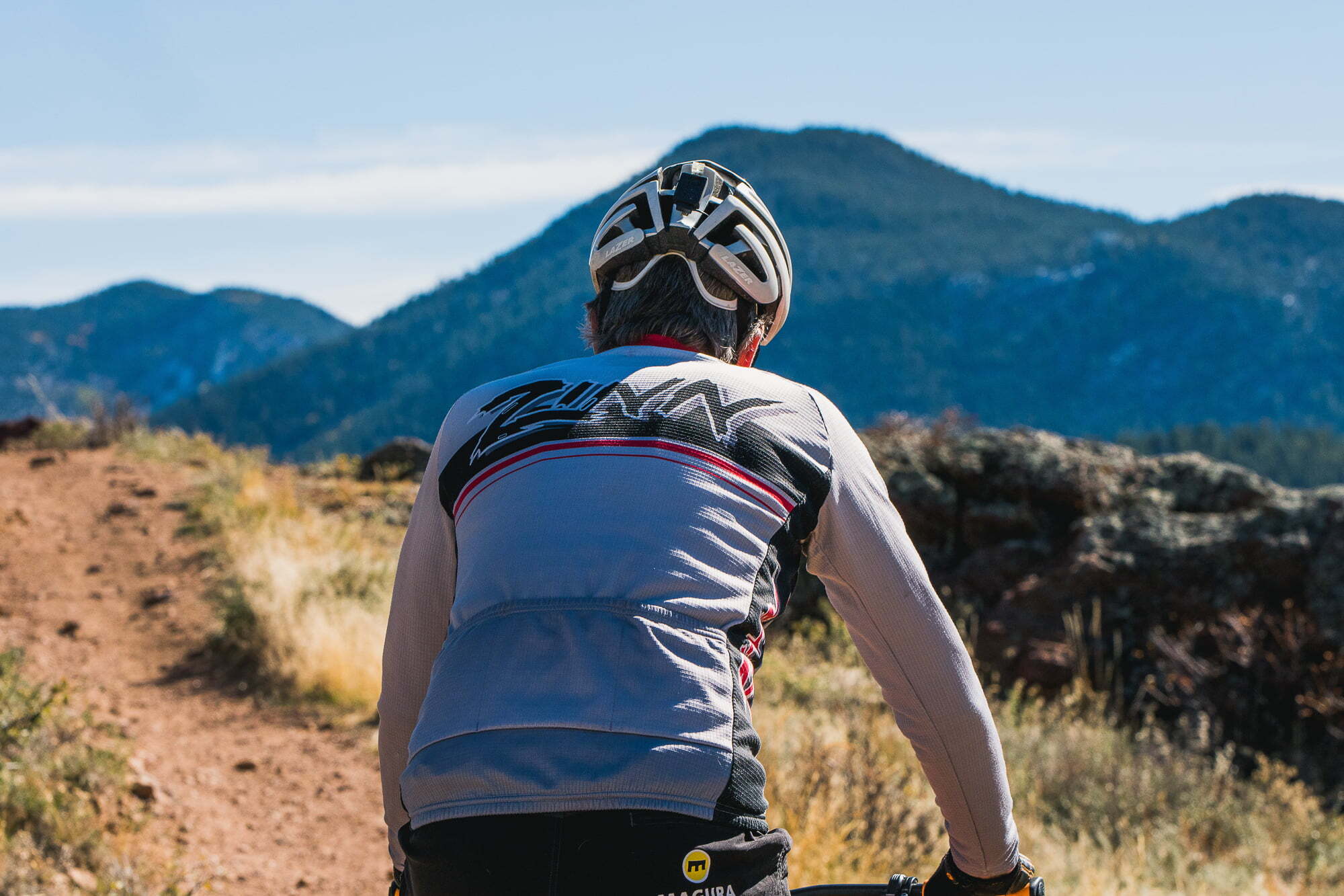 Bike rider wearing a helmet on a long trail ride in the mountains