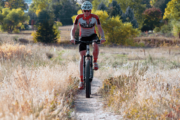 Lennard riding MTB toward camera